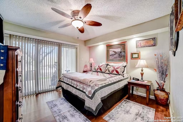 bedroom featuring access to exterior, a textured ceiling, dark hardwood / wood-style flooring, and ceiling fan