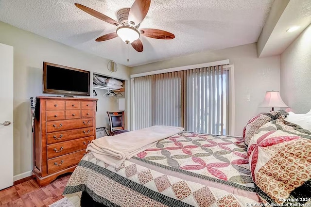 bedroom featuring ceiling fan, a textured ceiling, and hardwood / wood-style flooring