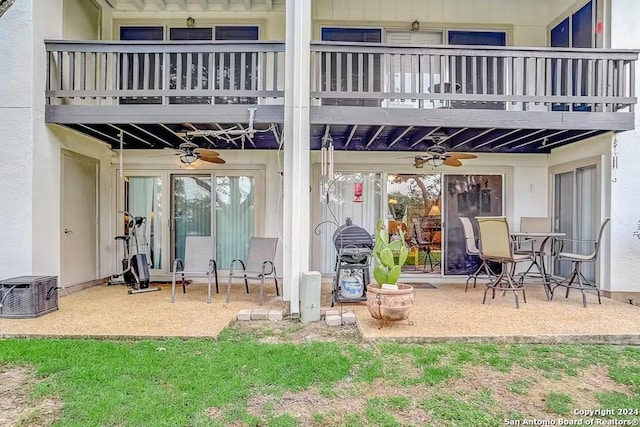 exterior space with ceiling fan and a balcony