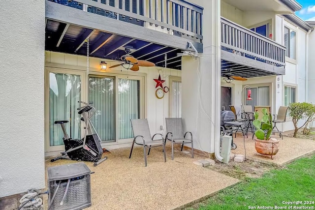 view of patio featuring ceiling fan and a balcony