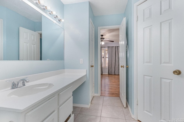 bathroom featuring ceiling fan, vanity, a textured ceiling, and hardwood / wood-style flooring