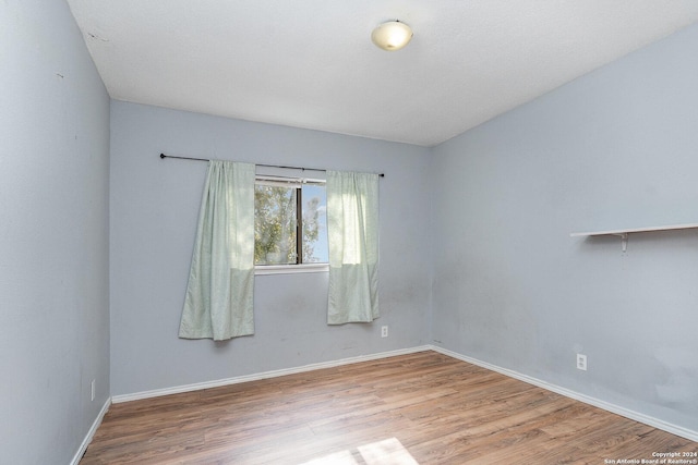 spare room with hardwood / wood-style flooring