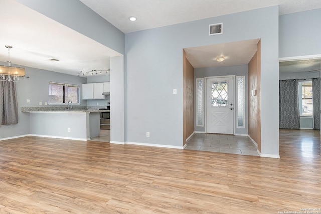 entryway with light wood-type flooring and sink