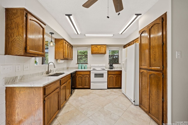 kitchen with ceiling fan, sink, pendant lighting, white appliances, and decorative backsplash