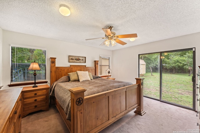 carpeted bedroom with ceiling fan, a textured ceiling, and access to outside