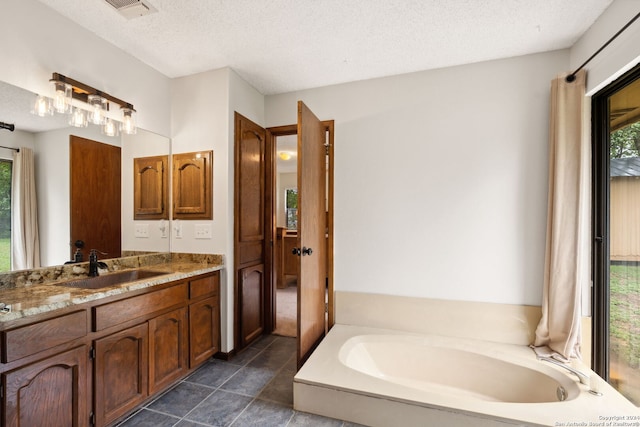 bathroom featuring a textured ceiling and plenty of natural light