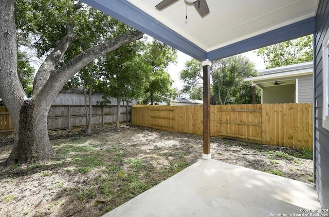 view of yard with ceiling fan and a patio