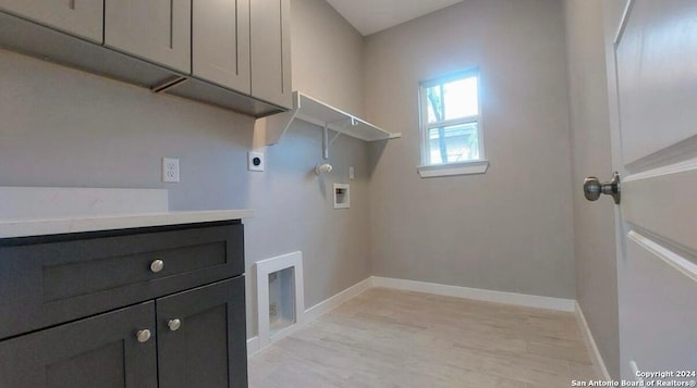 washroom with washer hookup, cabinets, hookup for an electric dryer, gas dryer hookup, and light hardwood / wood-style floors