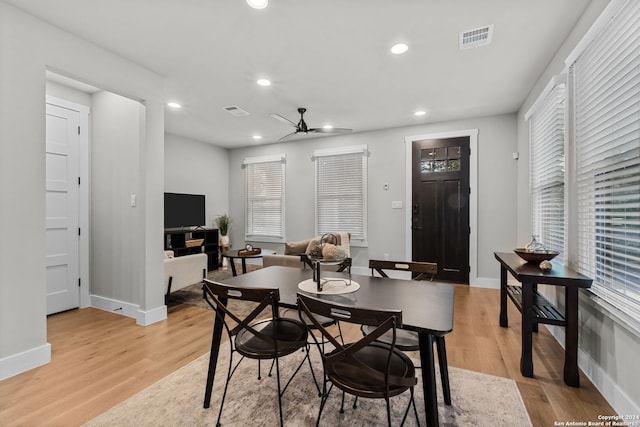 dining area with light hardwood / wood-style floors and ceiling fan