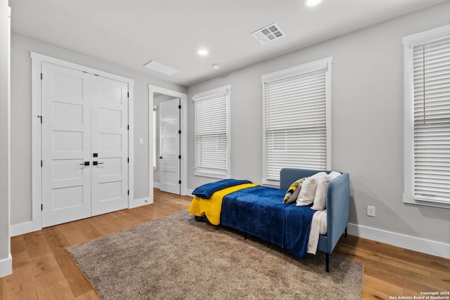 bedroom with wood-type flooring and a closet