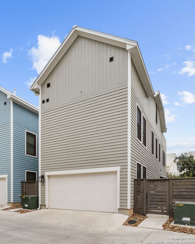 view of home's exterior featuring central AC and a garage