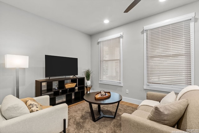 living room featuring hardwood / wood-style floors and ceiling fan