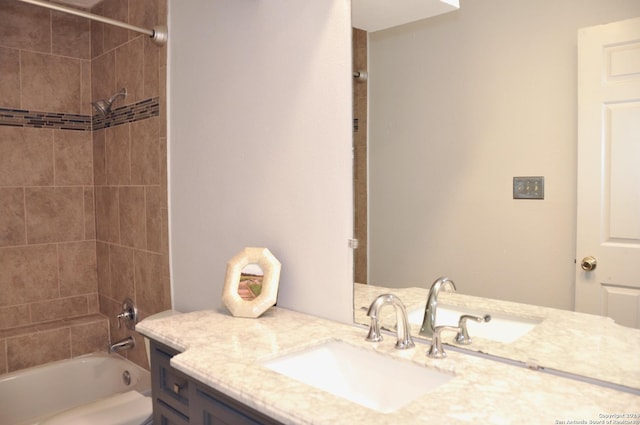 bathroom featuring vanity and tiled shower / bath