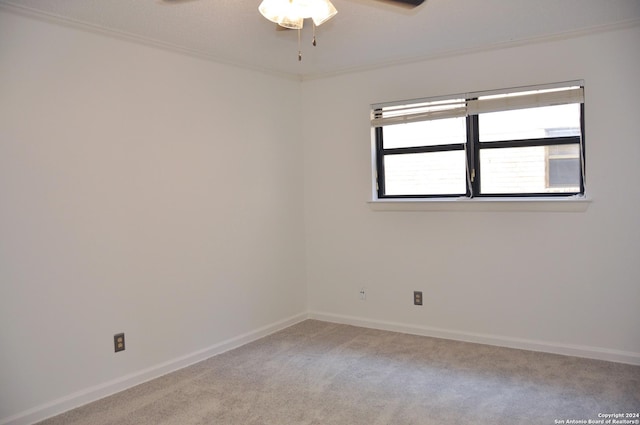 carpeted spare room with ceiling fan