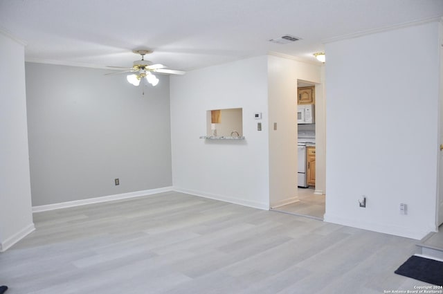 spare room featuring ceiling fan, light wood-type flooring, and crown molding