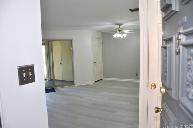 foyer with ceiling fan and light wood-type flooring