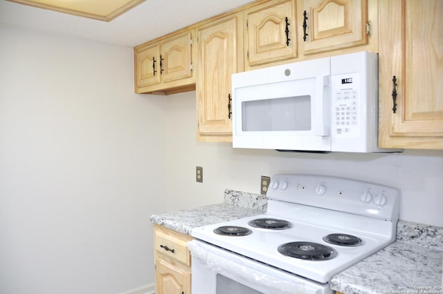 kitchen with a textured ceiling, light brown cabinetry, and white appliances