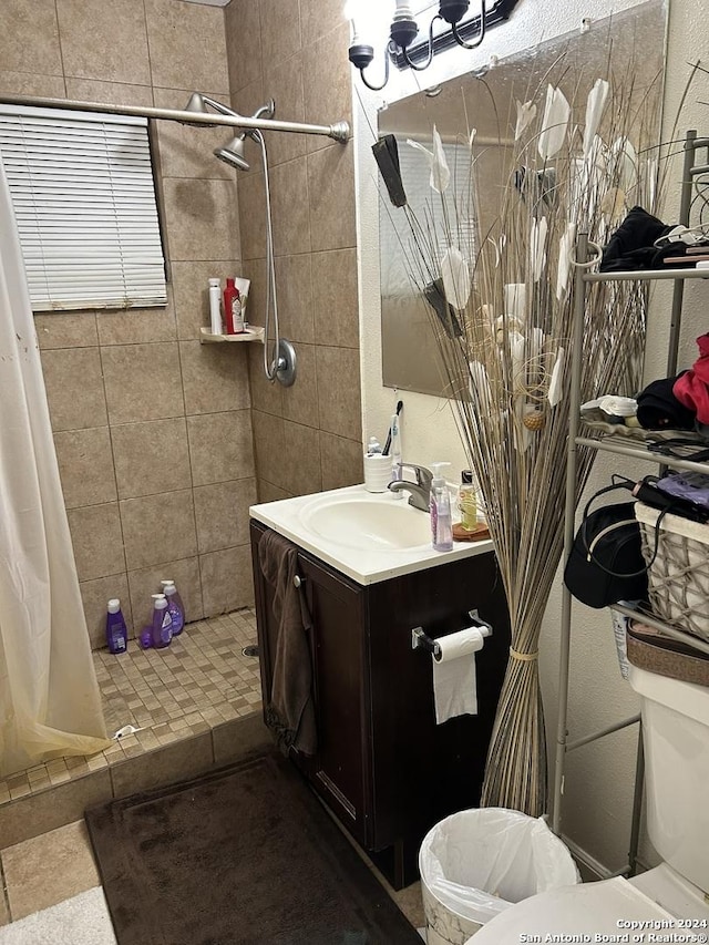 bathroom featuring curtained shower, vanity, and toilet