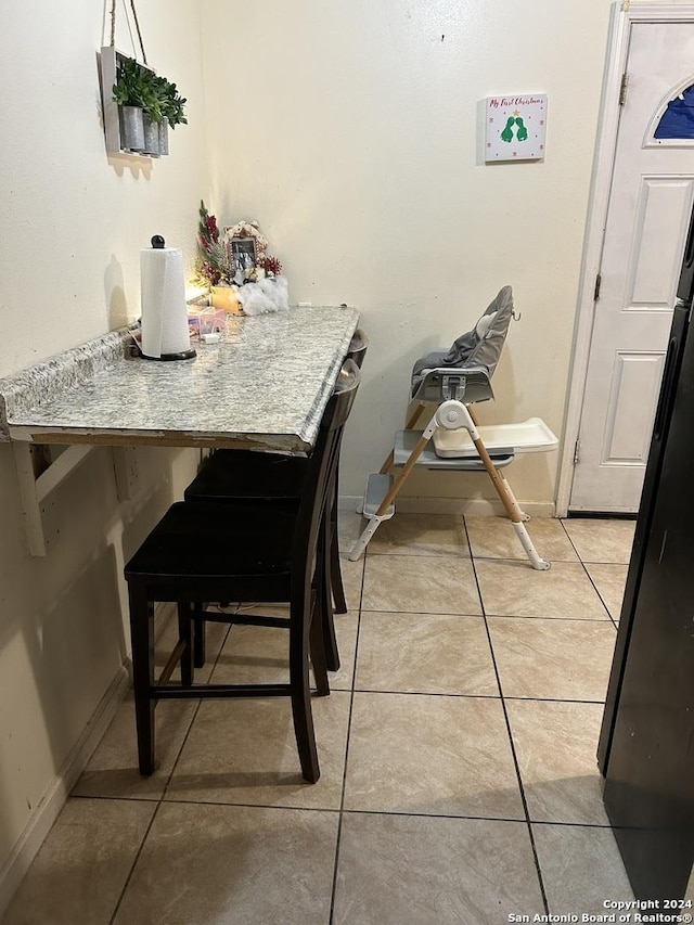 dining area featuring light tile patterned floors