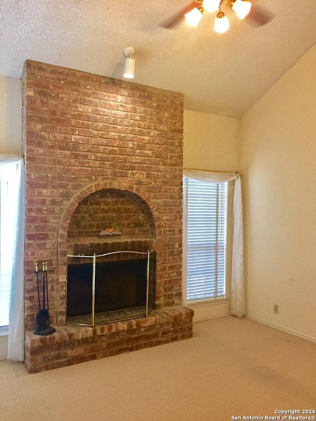 details featuring ceiling fan, a fireplace, carpet floors, and a textured ceiling