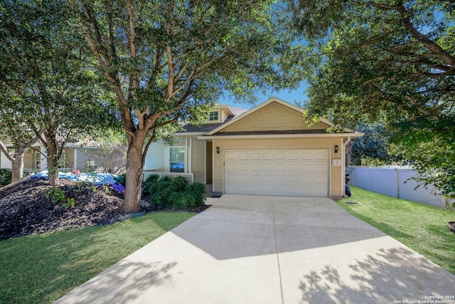 view of front of property featuring a garage and a front yard