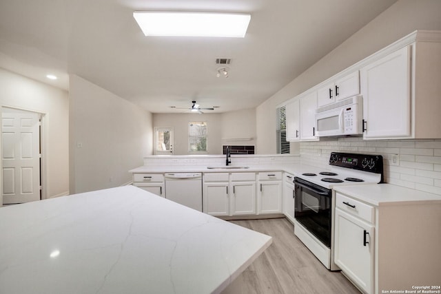 kitchen with white appliances, ceiling fan, sink, light hardwood / wood-style floors, and white cabinetry