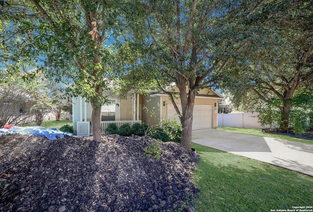 obstructed view of property featuring a front yard and a garage