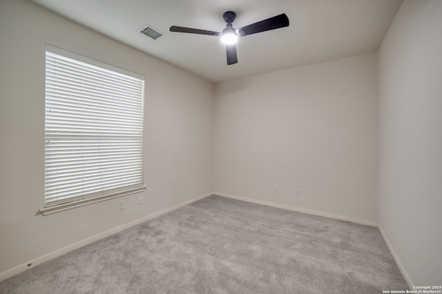 carpeted empty room with ceiling fan