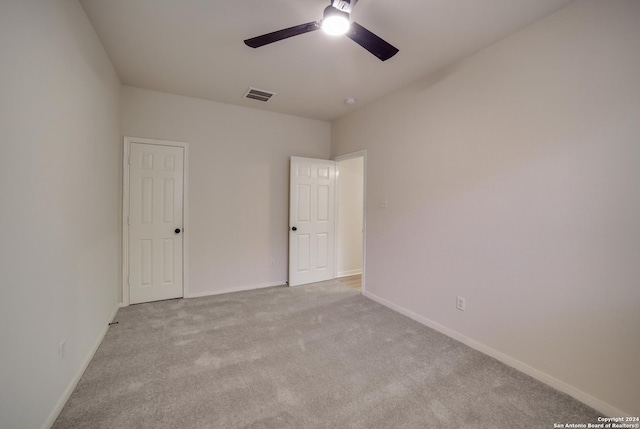 unfurnished room with ceiling fan and light colored carpet