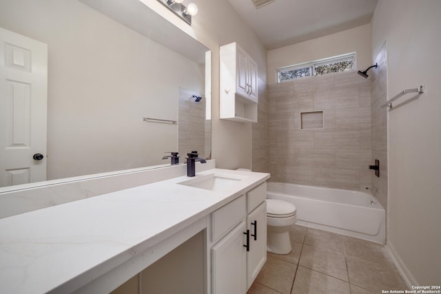 full bathroom featuring tile patterned floors, tiled shower / bath, vanity, and toilet