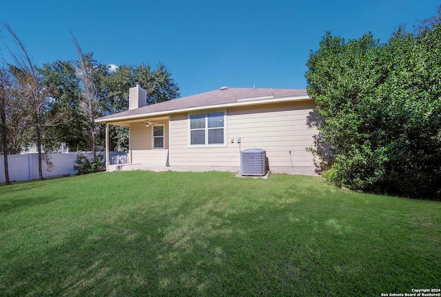 back of house featuring a yard, ceiling fan, and central air condition unit