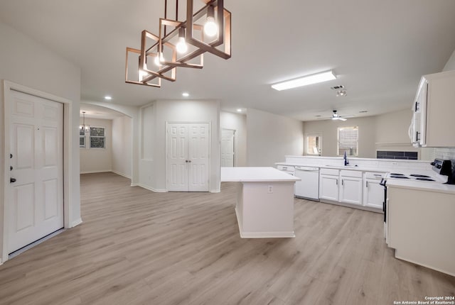 kitchen featuring pendant lighting, white appliances, white cabinetry, and a kitchen island