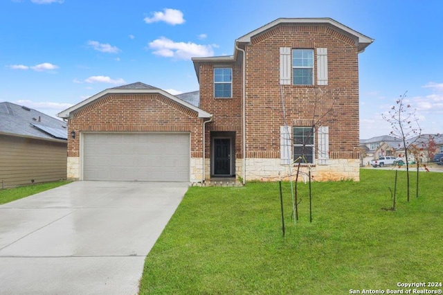 front facade featuring a front yard and a garage