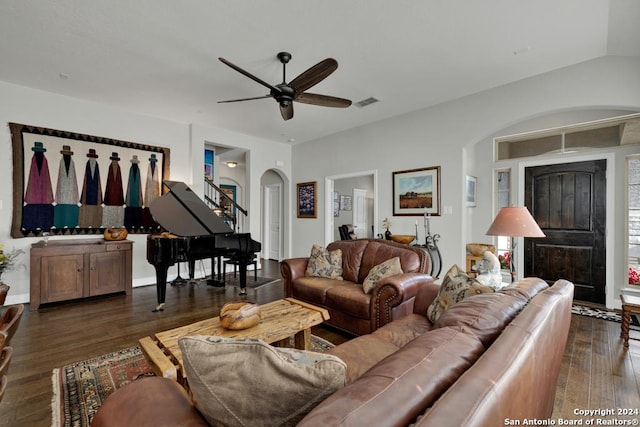 living room featuring dark hardwood / wood-style floors, vaulted ceiling, and ceiling fan