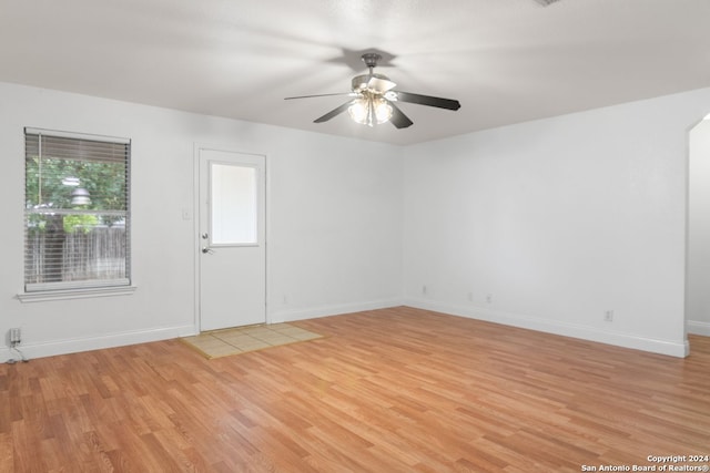 unfurnished room with ceiling fan and light hardwood / wood-style flooring