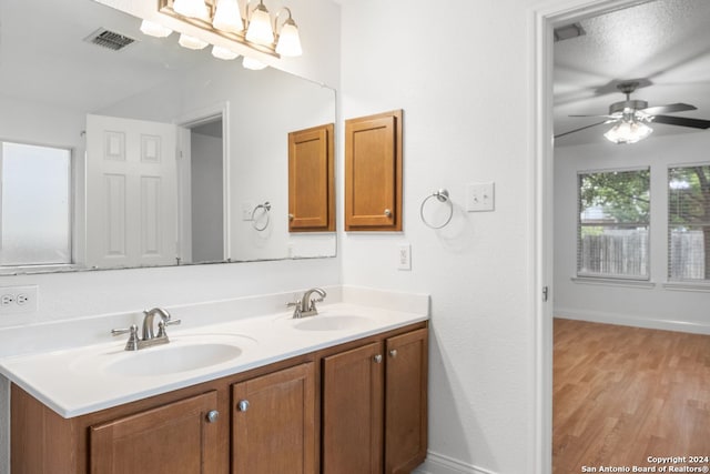 bathroom featuring hardwood / wood-style floors, vanity, and ceiling fan