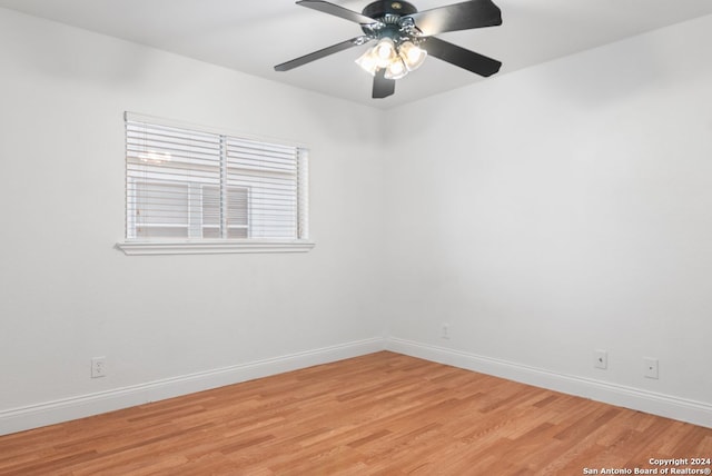 spare room with ceiling fan and light wood-type flooring