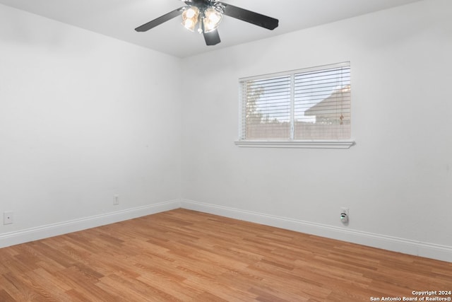 spare room with ceiling fan and light wood-type flooring