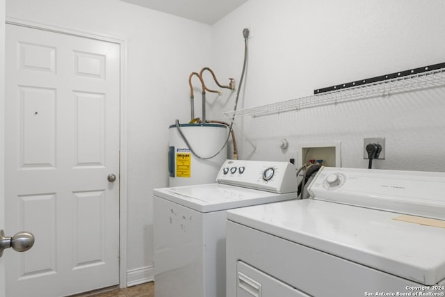 laundry area with independent washer and dryer, electric water heater, and light tile patterned floors