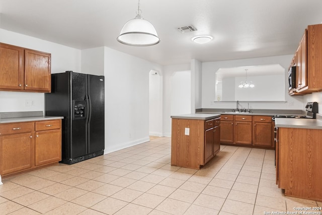 kitchen with light tile patterned flooring, sink, hanging light fixtures, a kitchen island, and black fridge with ice dispenser