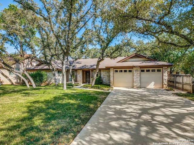 ranch-style house with a front yard and a garage