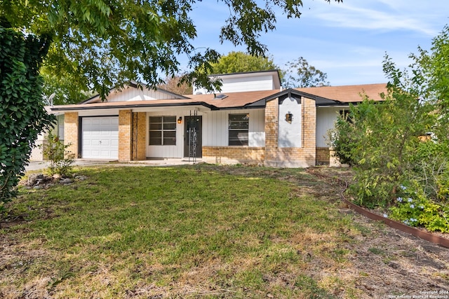 ranch-style house featuring a garage and a front lawn