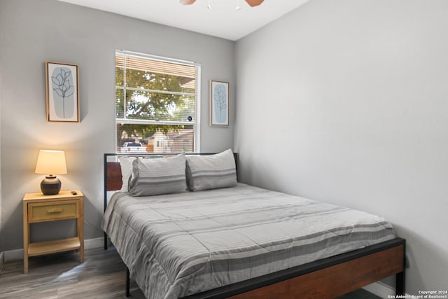 bedroom featuring ceiling fan and dark wood-type flooring