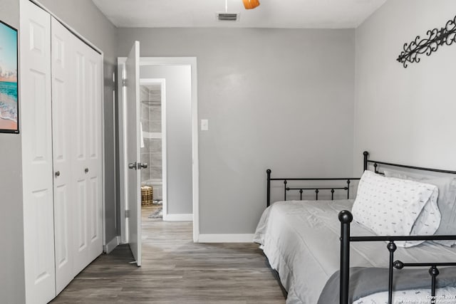 bedroom featuring dark hardwood / wood-style flooring and a closet