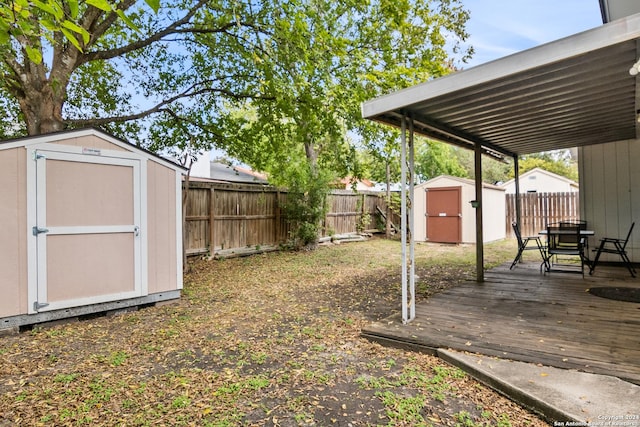 view of yard featuring a storage shed and a wooden deck