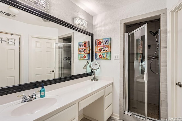 bathroom with vanity and a shower with shower door