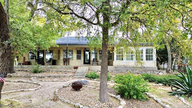 view of front of property with ceiling fan and a patio area