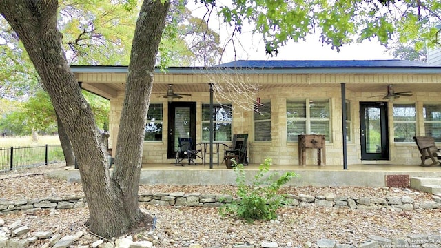 view of front of property featuring ceiling fan and covered porch