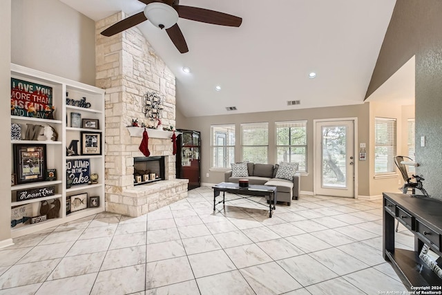 tiled living room with ceiling fan, a fireplace, and high vaulted ceiling