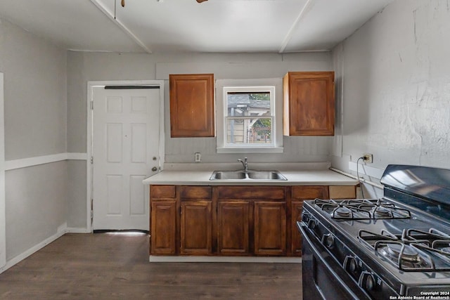 kitchen featuring sink, dark wood-type flooring, and black range with gas cooktop